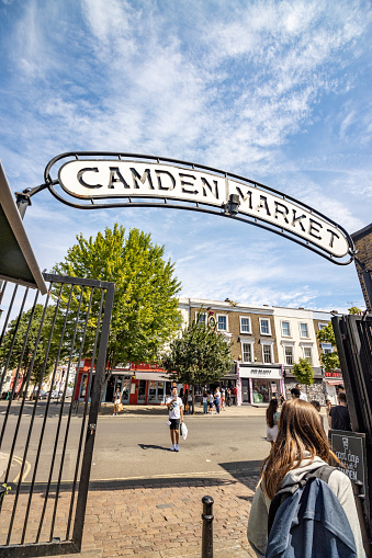 Entrance Sign to Camden Market in Borough of Camden, London, with people visible.