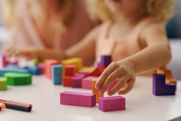 istock Child playing with wooden blocks 1412057486