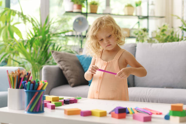 istock Cute girl coloring with markers 1412058875
