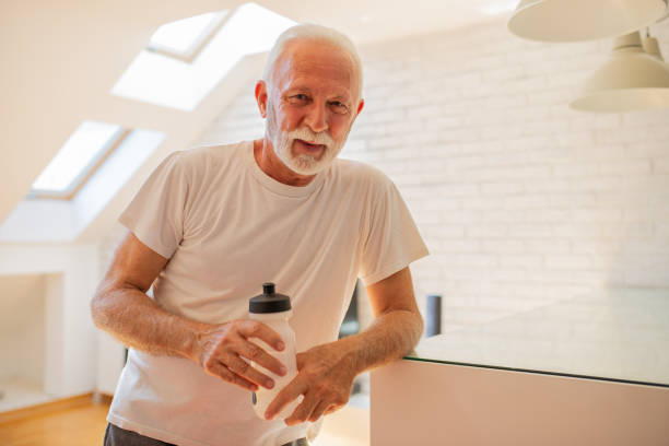 istock Senior man at home keeping fit by exercising 1412061385