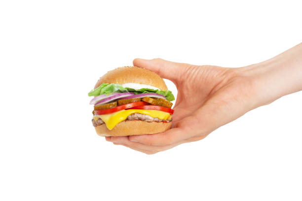 istock hamburger in hand on white isolated background 1412061567