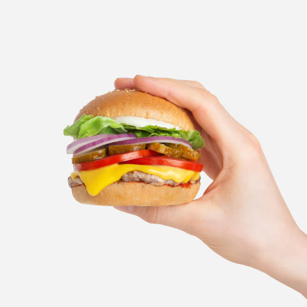 istock hamburger in hand on white isolated background 1412061969