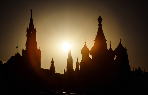 Moscow Kremlin and St Basil's Cathedral at sunset, Russia. Scenery of Moscow city center and sun in summer evening. Silhouettes of Moscow landmarks in sunlight. Tourism and travel in Russia theme.