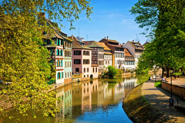 Quai de la Petite-France in Strasbourg, Alsace, France Ill navigation canal and Quai de la Petite-France in Strasbourg city, Alsace,  France. Located in the historic and tourist district of Petite France. Сovered walkway gives access to Rue des Moulins petite france strasbourg stock pictures, royalty-free photos & images