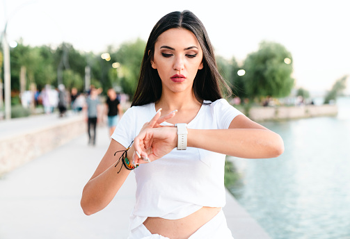 young woman looking at her smart watch