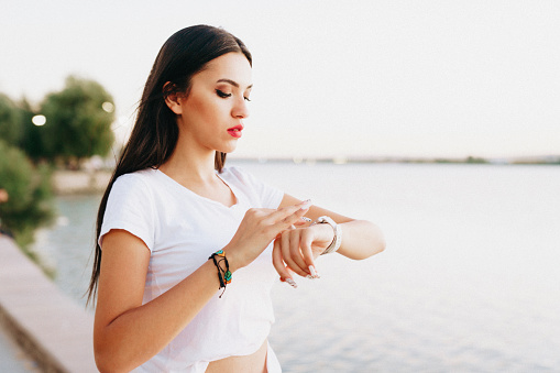 young woman looking at her smart watch