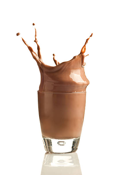 istock Chocolate splashing into glass tumbler against white 141208310