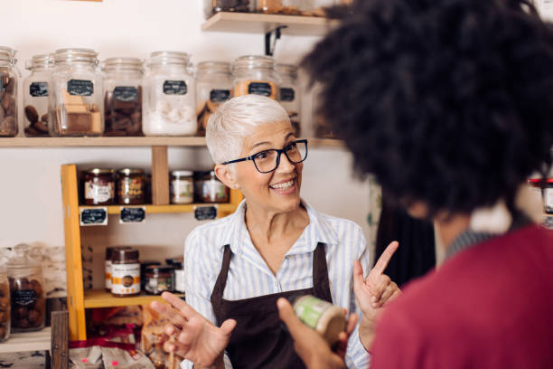 istock Kind senior saleswoman serving her customer 1412087061