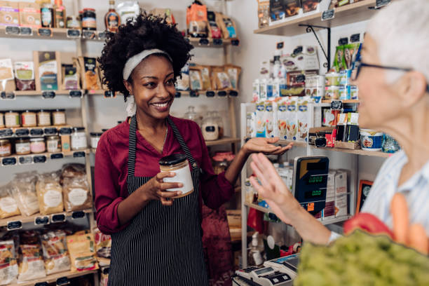 istock Kind Afro saleswoman advising her customer 1412087107