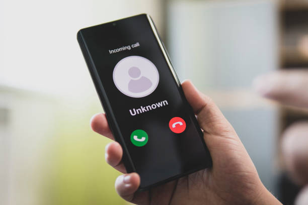 unknown number calling in the middle of the morning. phone call from stranger. person holding mobile and smartphone home. unknown caller. - girmek stok fotoğraflar ve resimler