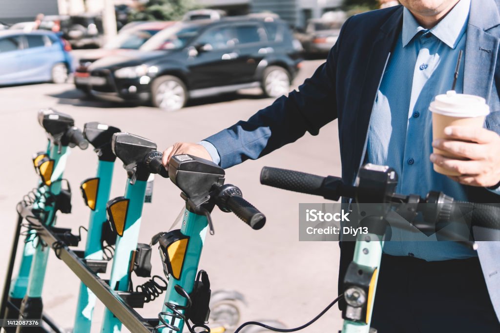 modern young man on an electric scooter in the city. Walk and rent eco-friendly electric vehicles modern man on an electric scooter in the city. Walk and rent eco-friendly electric vehicles Motorcycle Stock Photo