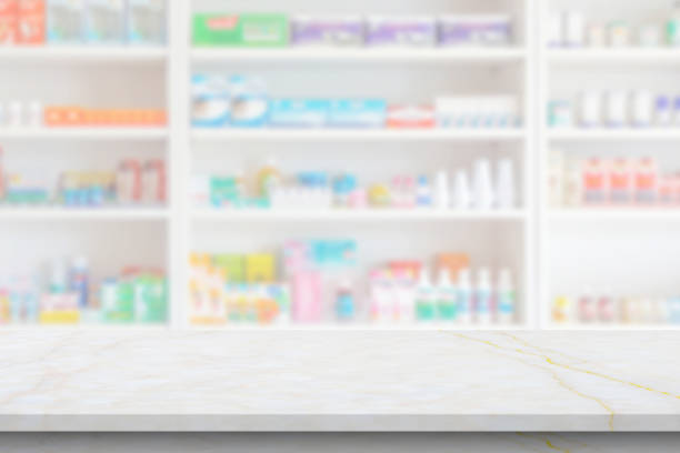 istock Empty white marble counter top with blur pharmacy drugstore shelves background 1412087670