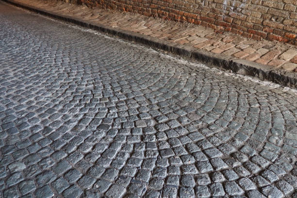 istock Paving stones - a hard road surface, a kind of pavement, lined with flat rectangular bars of the same shape and size. Block stone from which the road surface was built. Petrovaradin, Novi Sad, Serbia. 1412087785