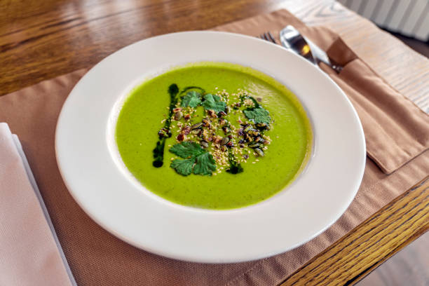 istock Spinach soup with cream in a bowl. Close up. 1412087908