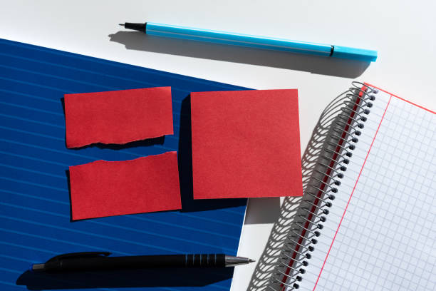 istock Sticky Note And Ripper Paper With Important Messages Placed On Desk With Notebook And Pens. Crutial Informations Presented On Memos On Table With Notepad. 1412089013