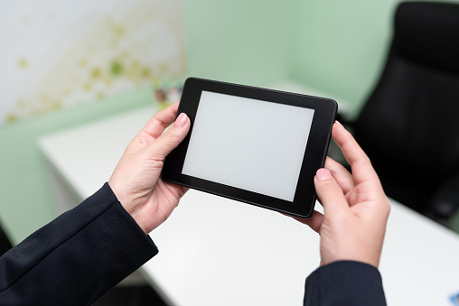 Businesswoman Holding Tablet With Important Informations On It.