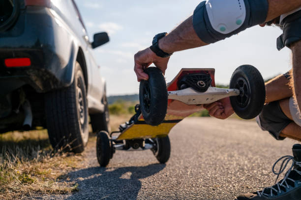 istock Man tries his electric mountainboard at sunset. 1412089766