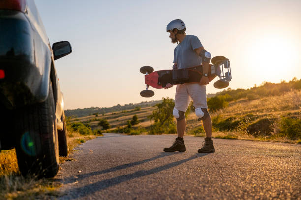 istock Man tries his electric mountainboard at sunset. 1412089776