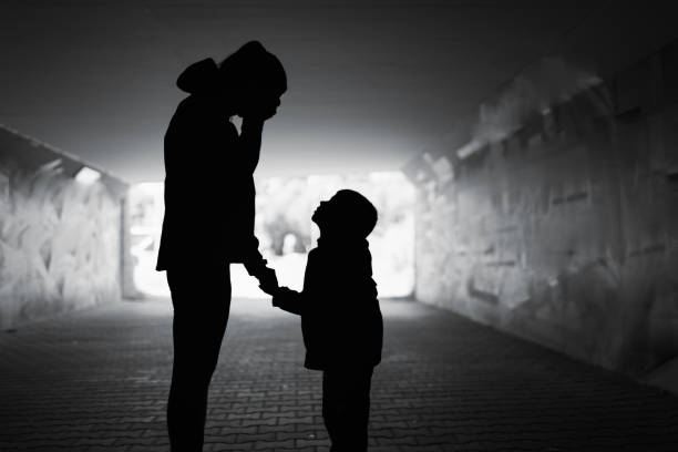 Mother crying next to her child. Family divorce, death and hardship, hopelessnes concept. sad child standing stock pictures, royalty-free photos & images