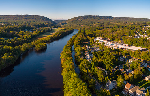 Aerial scenic view of the small American town Slatington lying along with the Lehigh River and historical Lehigh Chanel used for coal transportation, Lehigh Valley, Pennsylvania, USA, on a sunny evening in the early autumn.