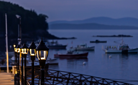 Lights illuminate the walkway down to the dock on a peaceful summer evening in Bar Harbor