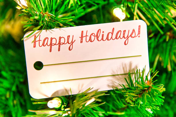 A Happy Holidays Card in an illuminated Christmas tree.