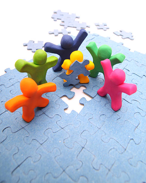 istock Multicolored colored cartoon people and a puzzle 141209929