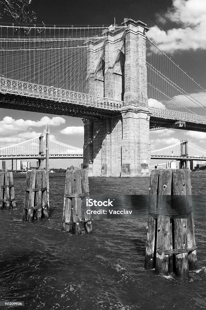 Brooklyn bridge in New York City black and white Brooklyn bridge in New York City with beautiful clouds in background, black and white view. Architectural Column Stock Photo