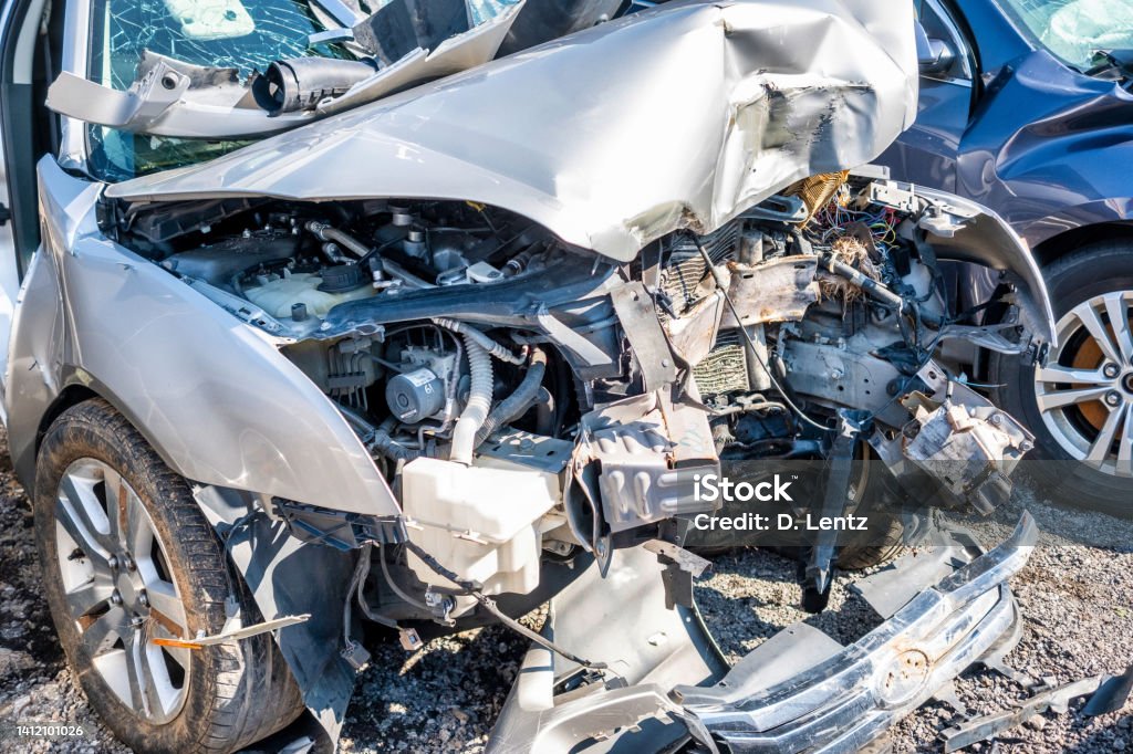 Totaled Car The wrecked in front end of a passenger car. Car Accident Stock Photo