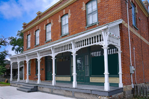 Ontario, Canada - July 31, 2022:  Old fashioned brick building with full width front porch, originally a rural general store from the 1890s