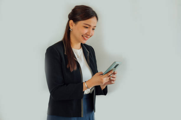 istock Asian businesswoman using smartphone in office 1412102985
