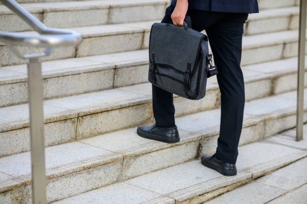 istock Busnessman walking upstairs 1412103933
