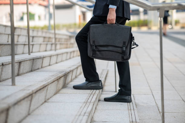 istock Busnessman walking upstairs 1412103934