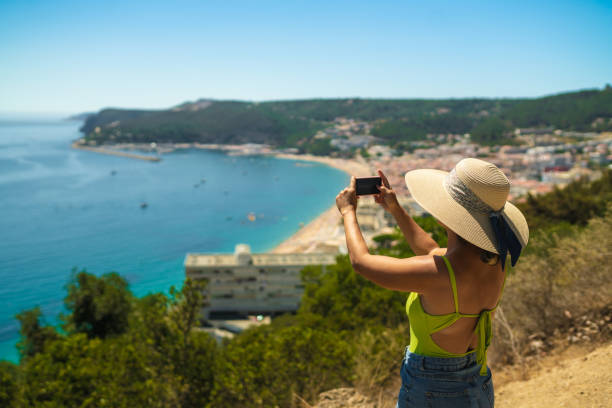 istock Tourist photographing Sesimbra beach 1412106121