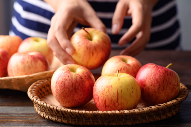 istock Red apple fruit in basket with woman hand 1412107740