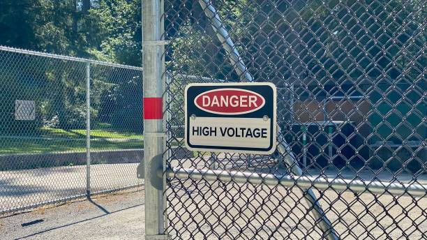 istock Danger high voltage sign fence no entry safety protocols code sunny day notice red restriction keep out 1412112381