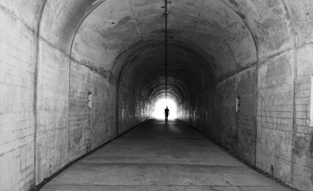 istock Walking in Tunnel into the light 1412117479