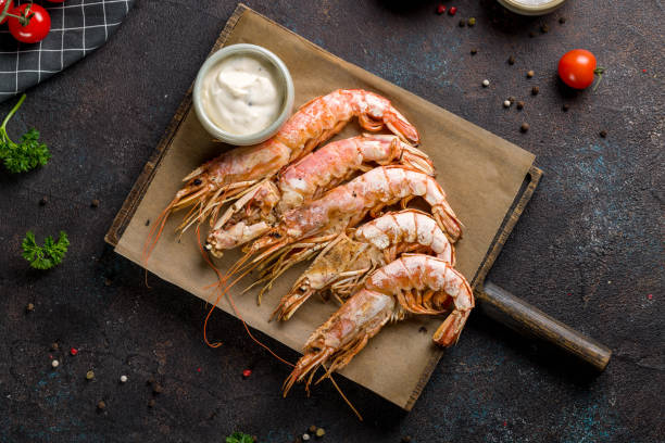 istock Fried langoustines on the Board with sauce top view on dark stone table 1412117592
