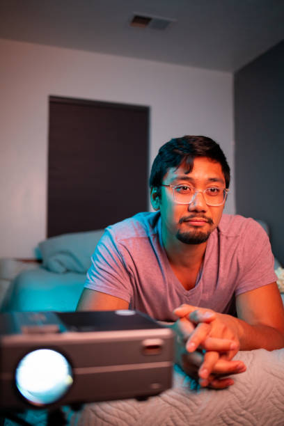 (Interested) Man Watching a Movie in Bed with Projector