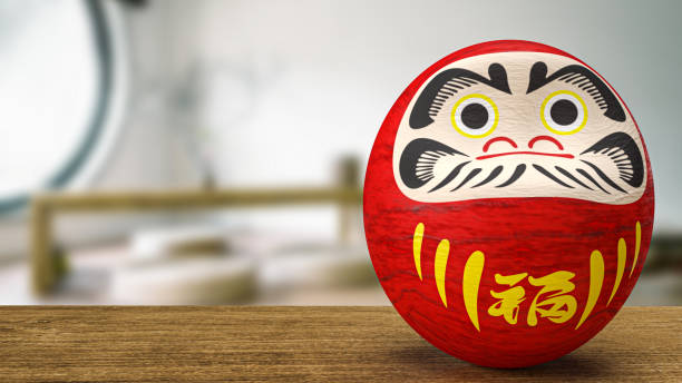 istock daruma Japanese doll on wood table 3d rendering 1412131757