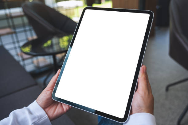 istock Mockup image of a woman holding digital tablet with blank white desktop screen 1412134469