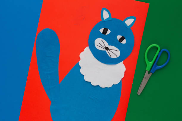 Flat lay paper craft made by child and scissors