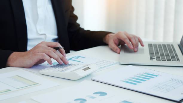 istock Business people working on desk and analysis about summary budget finance and using laptop making note report. 1412136173
