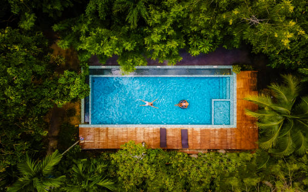 aerial view with drone above swimming pool in jungle of Thailand stock photo
