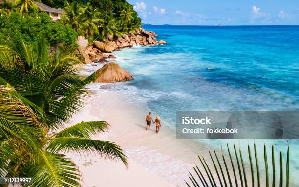 Anse Source Dargent La Digue Seychelles Young Couple Men And Woman On A Tropical Beach During A Luxury Vacation In The Seychelles Tropical Beach Anse Source Dargent La Digue Seychelles Stock Photo - Download Image Now