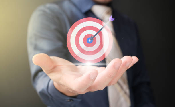 istock Businesspeople holding a target board to focus on achieving business objectives. 1412141177
