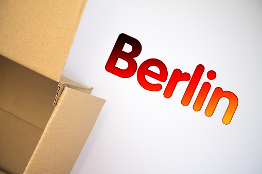Berlin word with cardboard box. Brown folded cardbox.