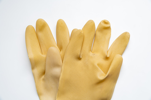 Yellow rubber gloves on white background