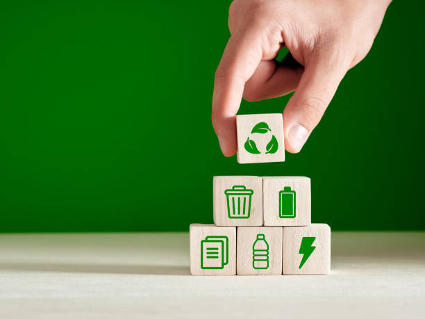 Recycling and environmental protection concept. Environment sustainable development. Recycling and environmental protection concept. Environment sustainable development. Hand puts recycling product material symbols on green background. sustainable business stock pictures, royalty-free photos & images