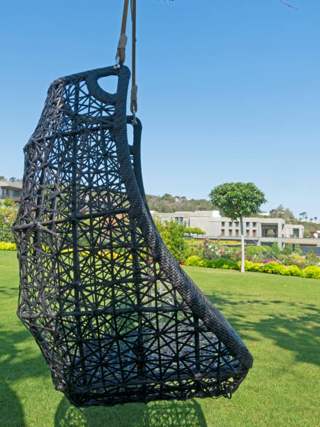 istock Hanging wicker chair for relaxing in the garden. 1412147828